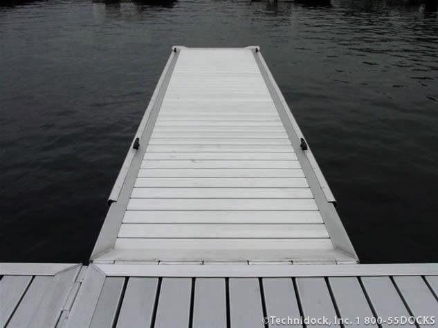 TechniDock commercial aluminum dock section extending over dark water