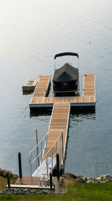 TechniDock aluminum residential dock with gangway and pontoon boat moored at Sacandaga Lake