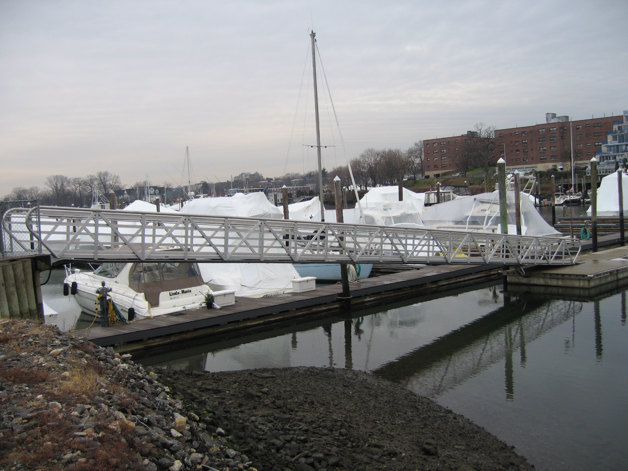 TechniDock 4x80 ADA aluminum gangway spanning marina with winter-wrapped boats