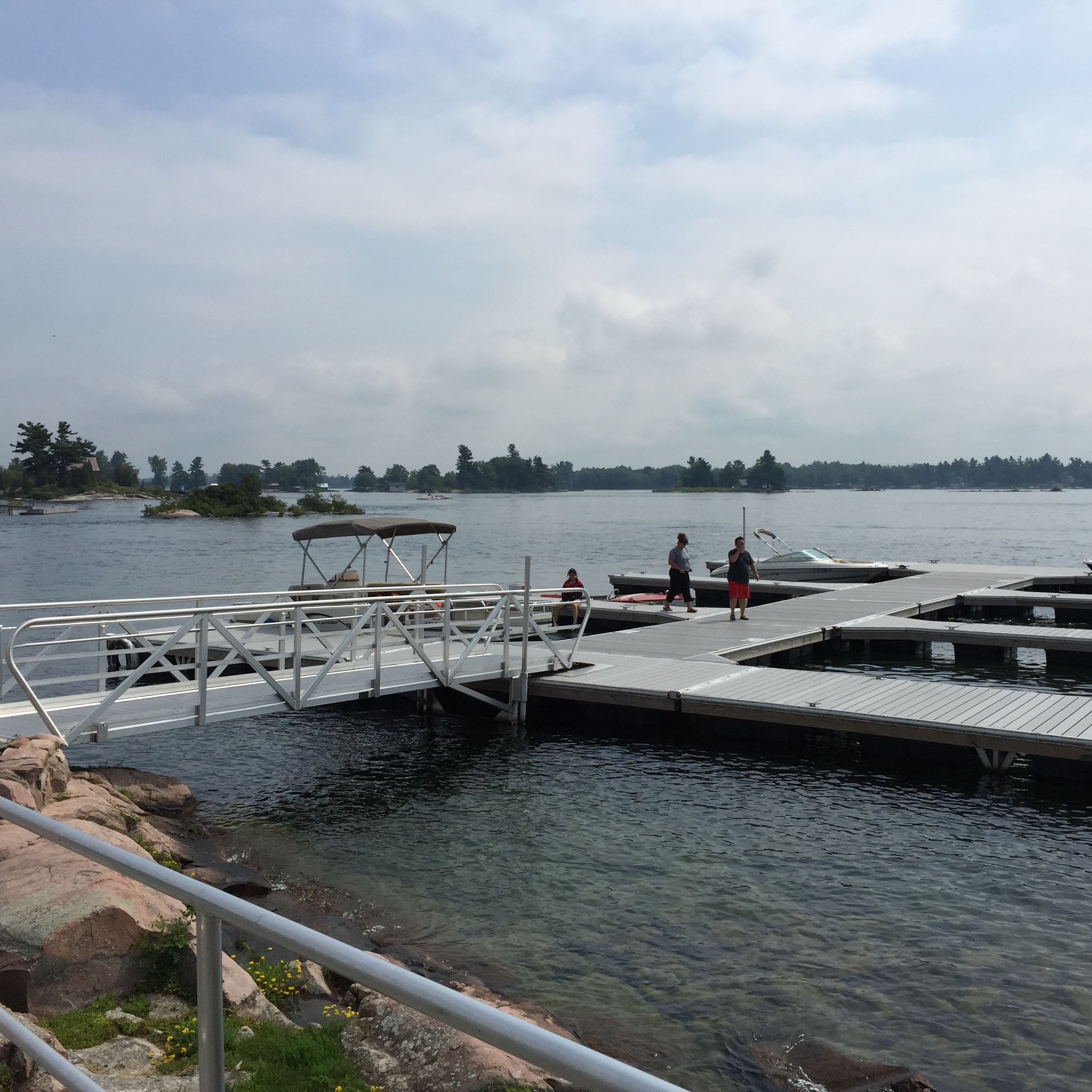 TechniDock aluminum gangway connecting rocky shoreline to floating dock system
