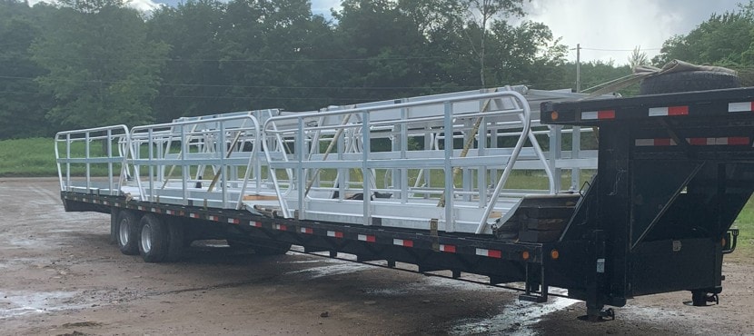Stack of TechniDock aluminum gangways on flatbed trailer
